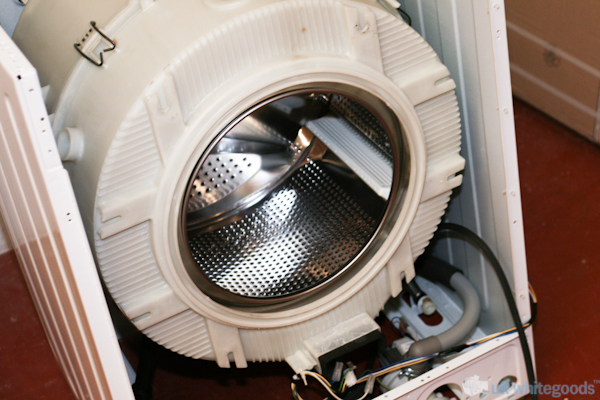 Inside Of A Modern Washing Machine :: This picture shows more of the washing machine outer tank and the spring clip holding it together