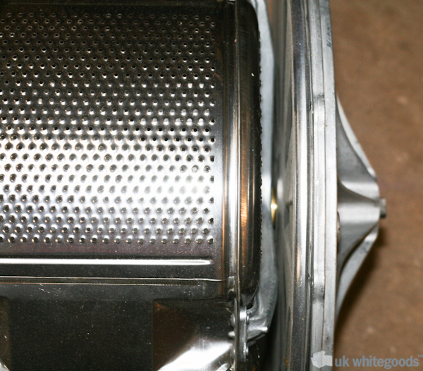 Washing Machine Drum and Rear Bearing Plate :: The inner drum (left) of the washing machine has the rear bearing shaft going through the rear plate where the bearings are housed