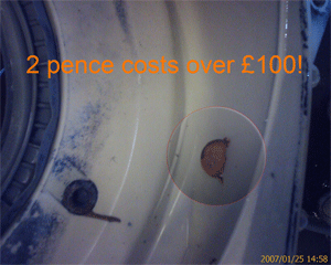 Coin pierces the drum of a washing machine