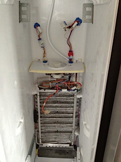 The evaporator and fan motor in a GE American fridge freezer