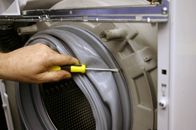 the washing machine door seal inner clamp band being pulled off