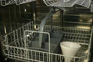 A typical dishwasher inside showing baskets and cutlery basket