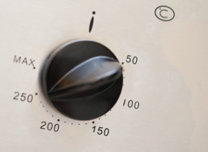 A typical oven thermostat control knob showing the temperature settings