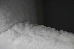 Ice build up around the freezer compartment of a fridge caused by air getting into the fridge