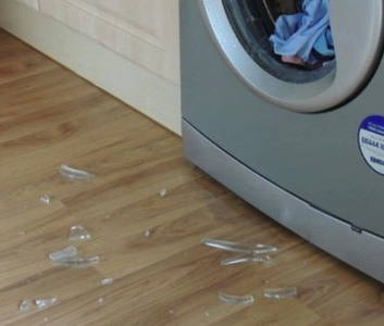 A classic example of a shattered washing machine door glass