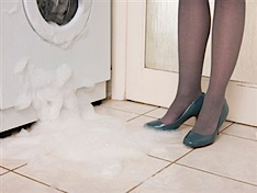 A washing machine leaking foam from the door