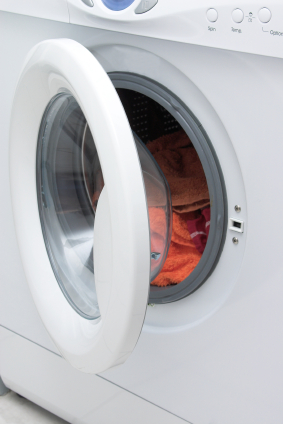 washing machine door open with clothes
