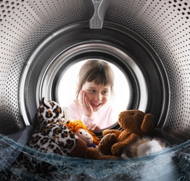 Child looking into a washing machine