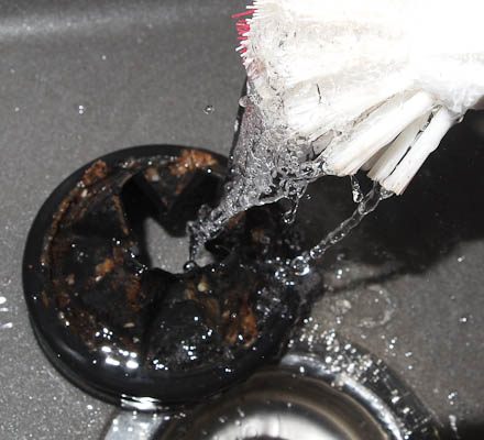 Starting to clean the rubber feed guard on the waste disposer